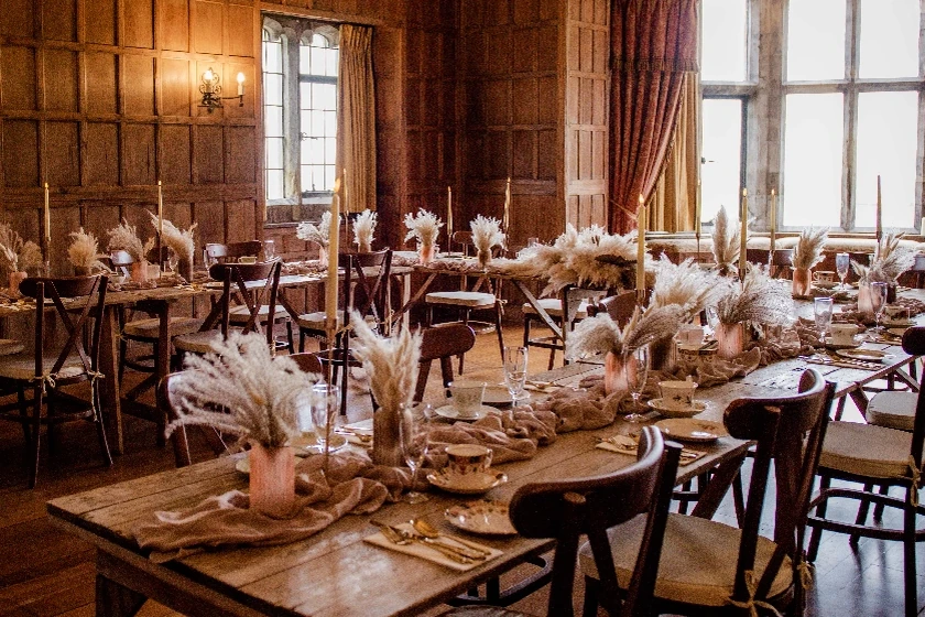 West wing ceremony room dining set-up with oak cross-back chairs