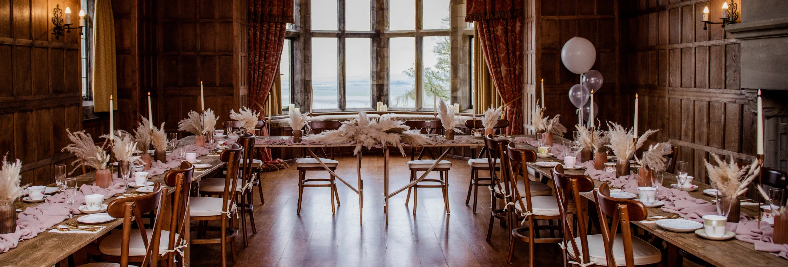 West wing ceremony room set for a celebration with oak cross-back chairs